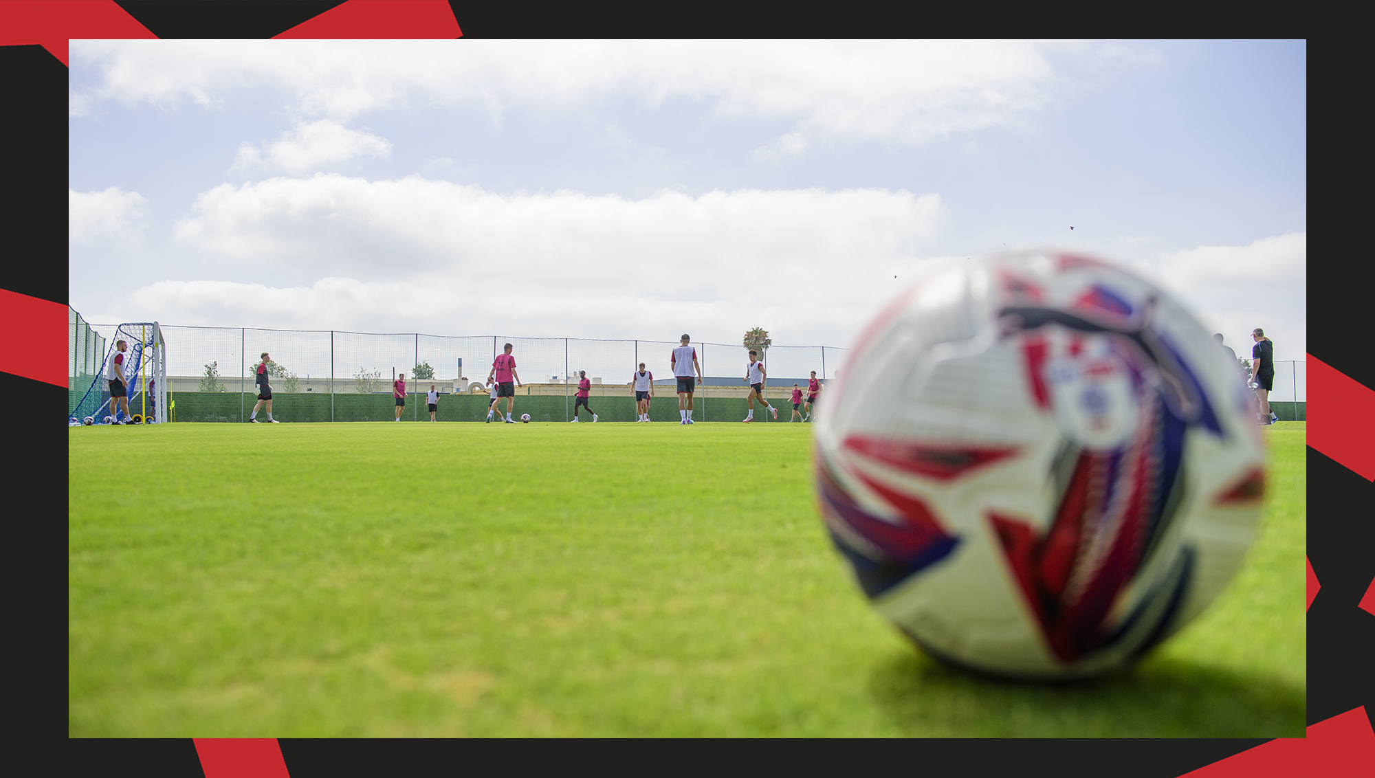 A football is pictured as Lincoln City's players are training in the background.