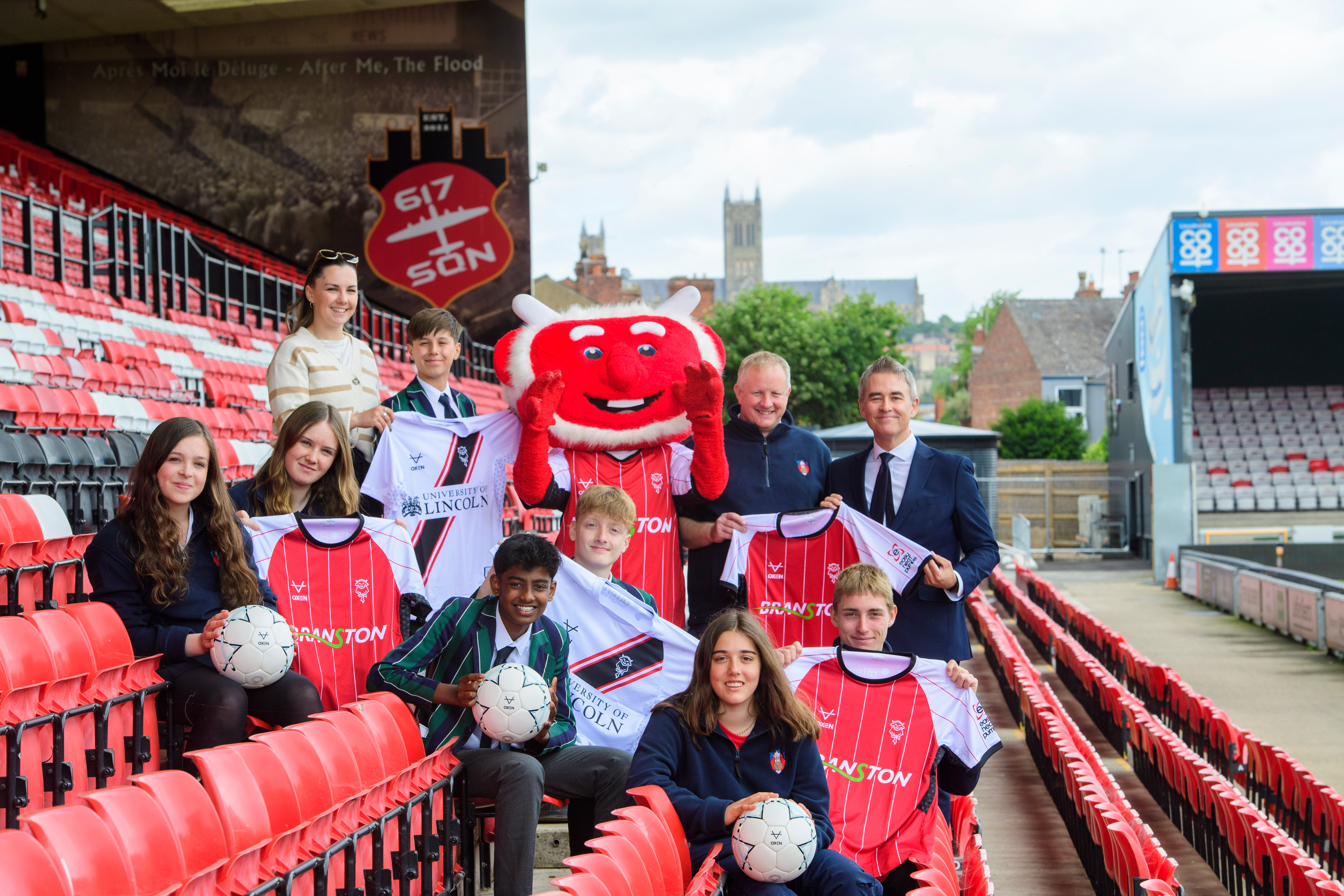 Students from Lincoln Minster pictured with Poacher the Imp after being donated shirts by Lincoln City