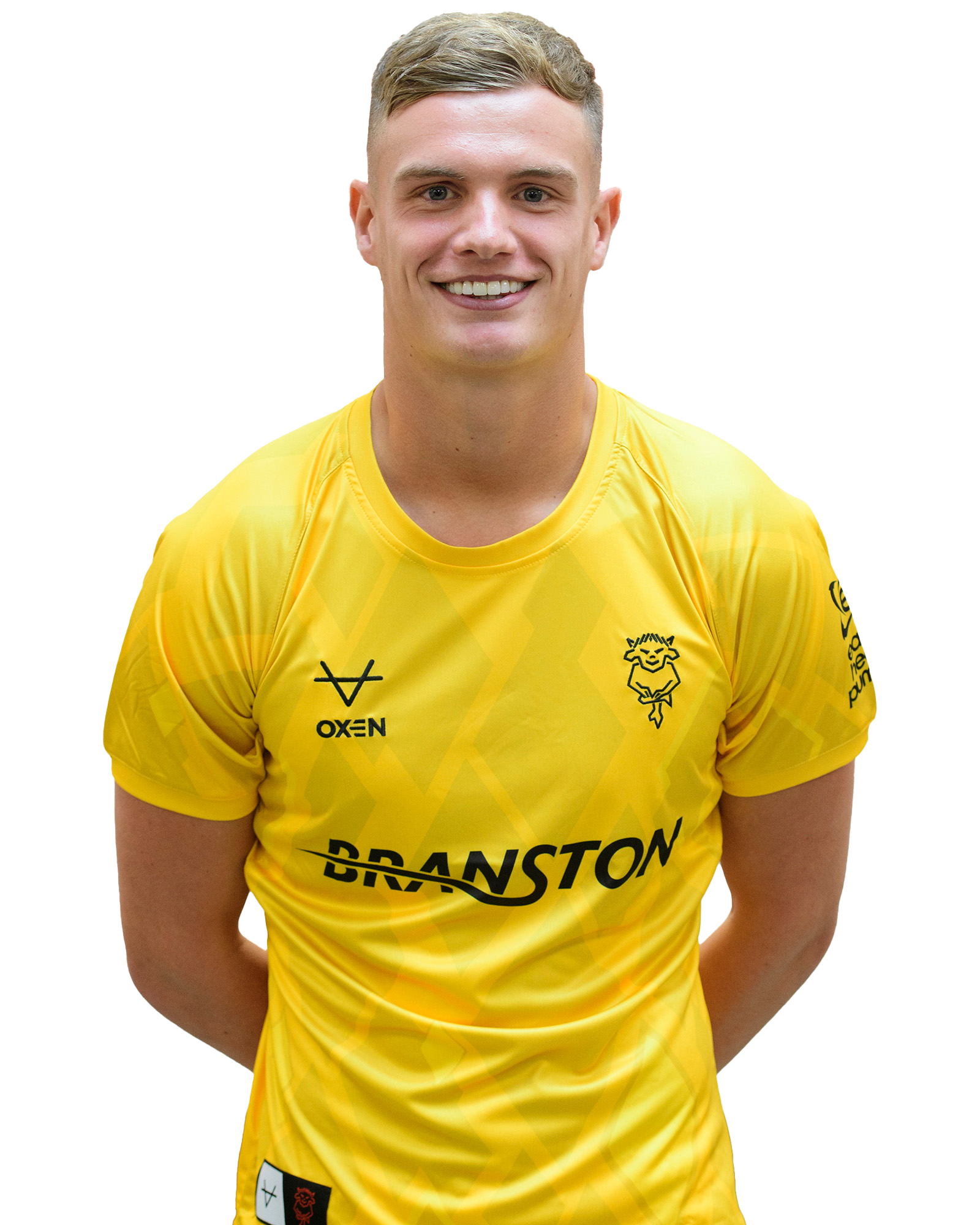 George Wickens poses for a picture wearing an all-yellow goalkeeper top.