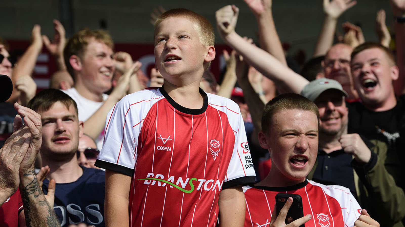 A young Lincoln City fan supporting his team against Burton Albion.