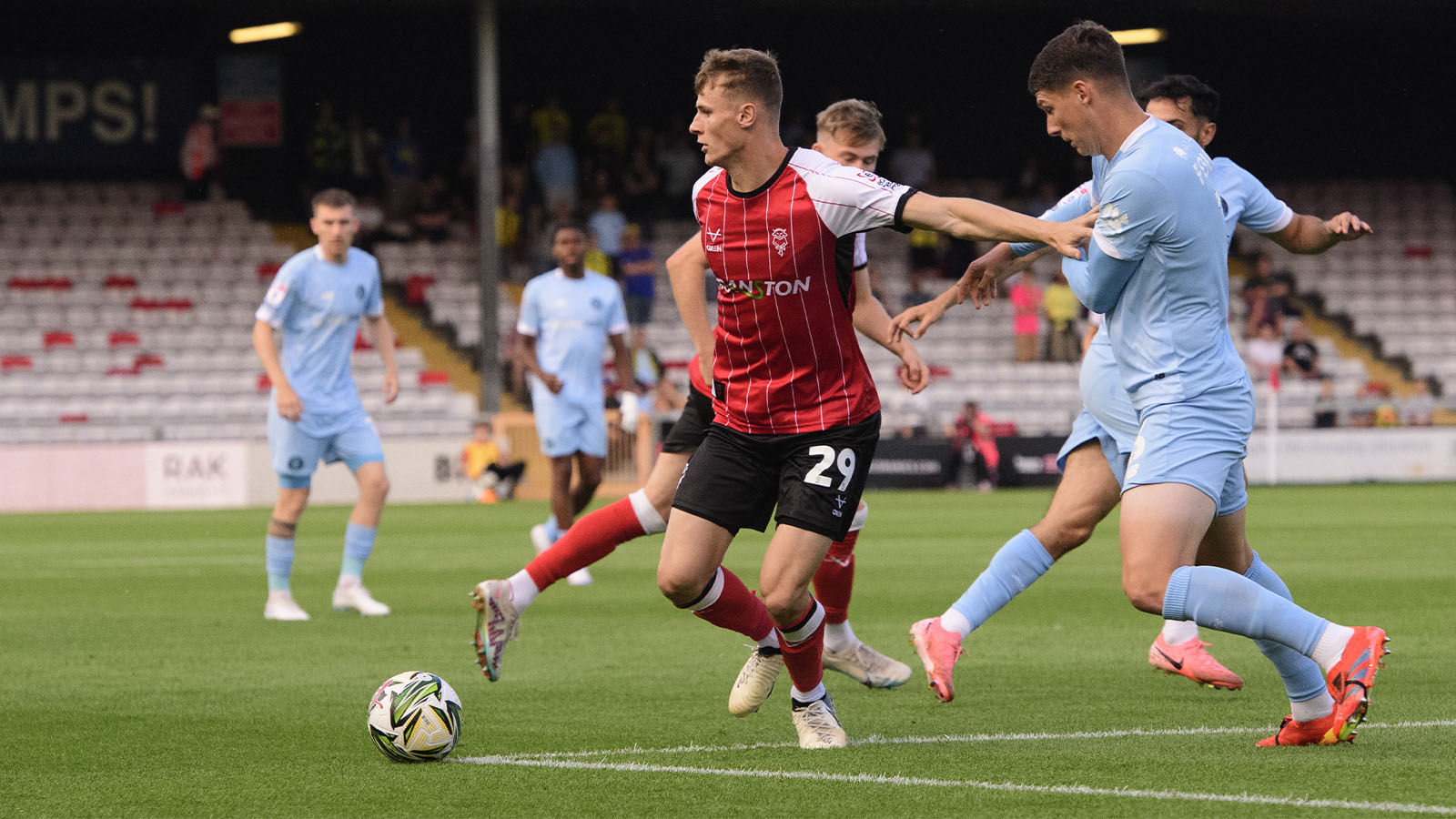 Rob Street holds up the ball for Lincoln City against Harrogate Town.