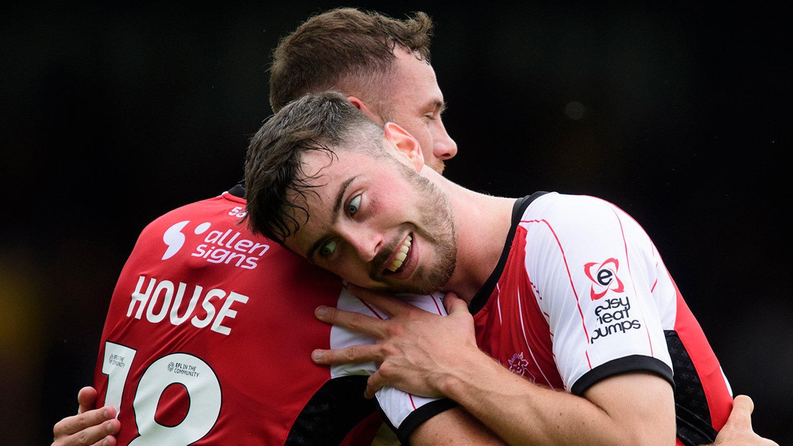 Ben House and Sean Roughan celebrate during Lincoln City's 4-1 home win over Mansfield Town.