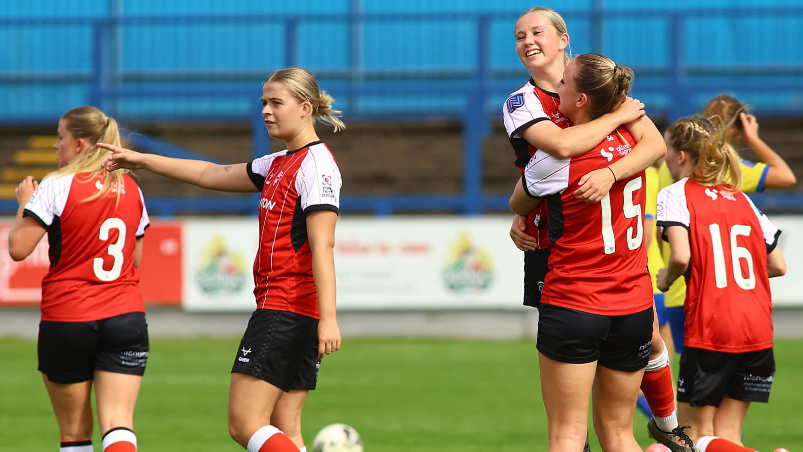 Lincoln City Women players celebrate a goal.