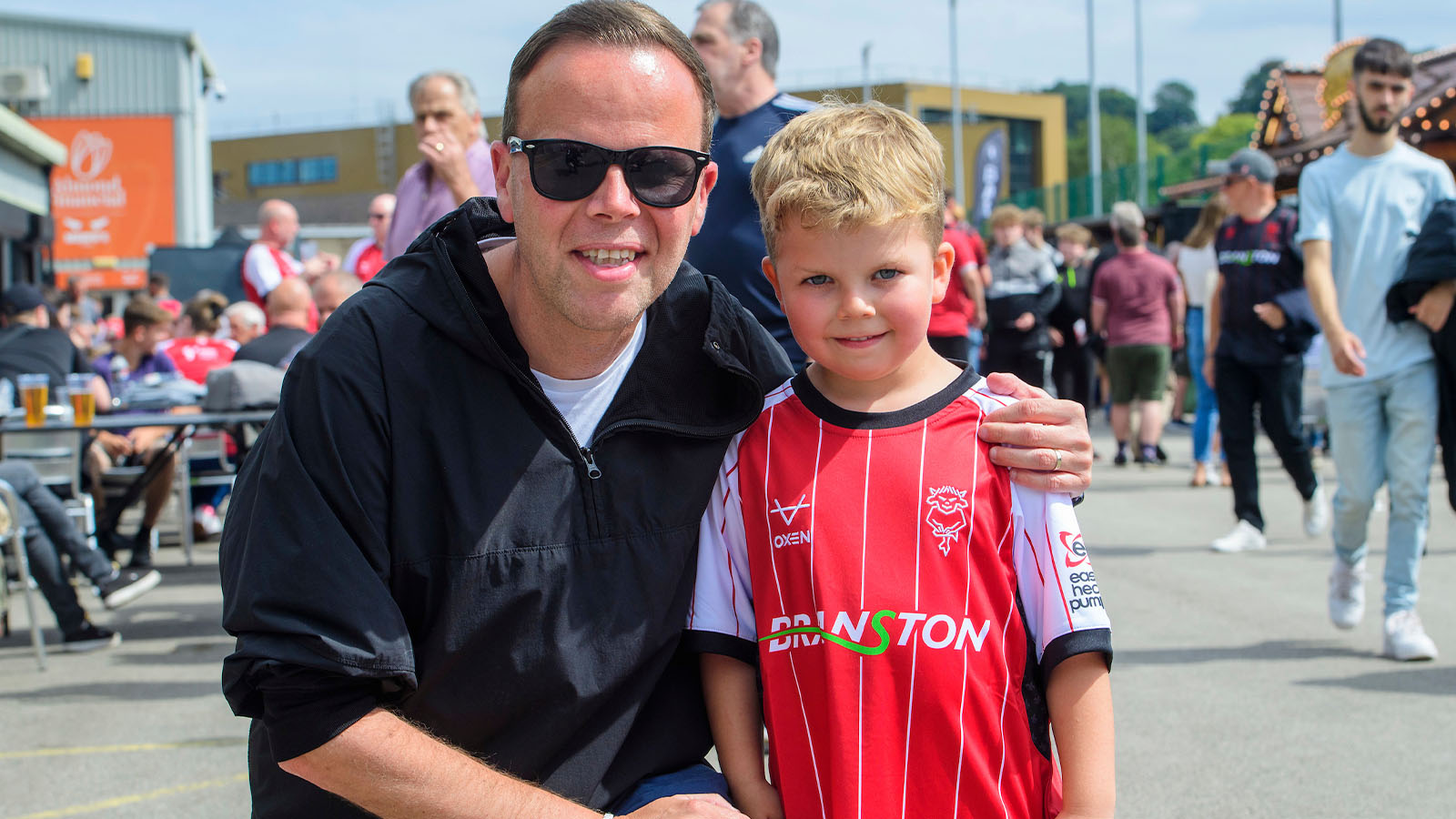 A young fan and their guardian at the LNER Stadium.