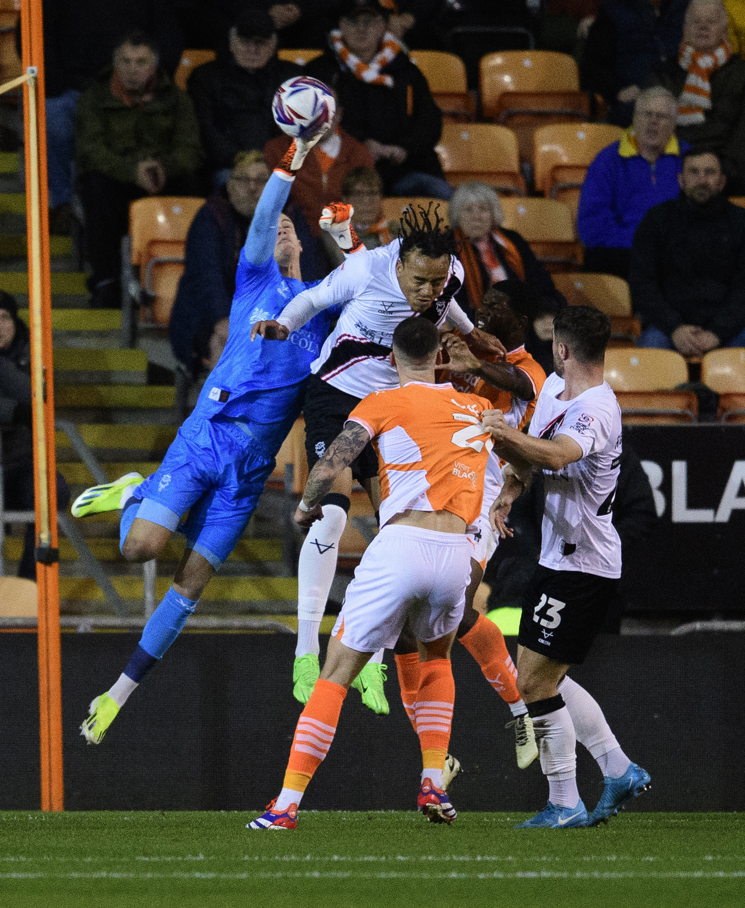 George Wickens punches away the danger following a Blackpool ball into the 18-yard box.