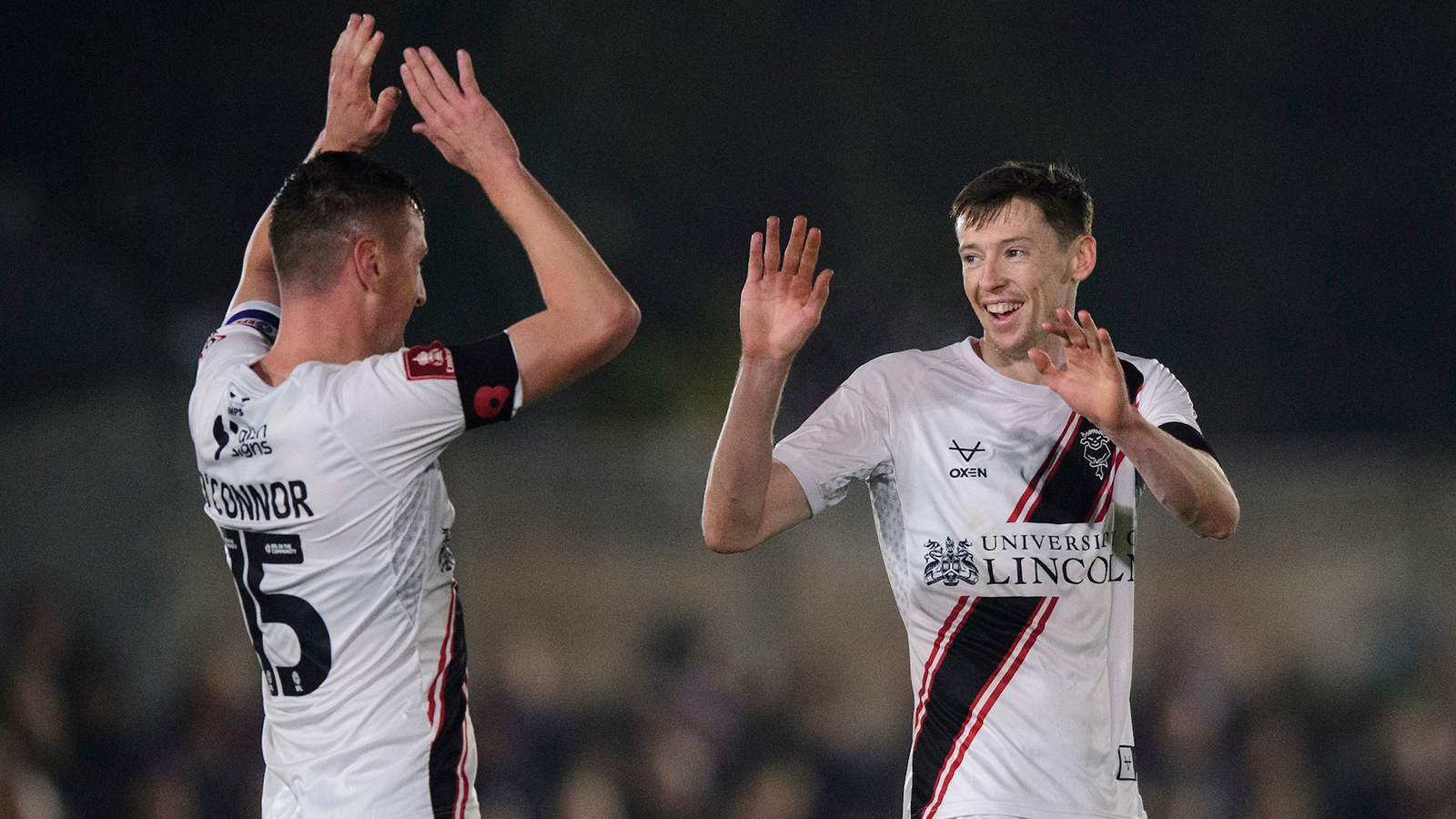 Paudie O'Connor congratulates Conor McGrandles on his goal at Chesham