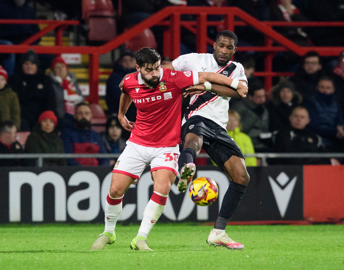 Tendayi Darikwa battles for possession at Wrexham