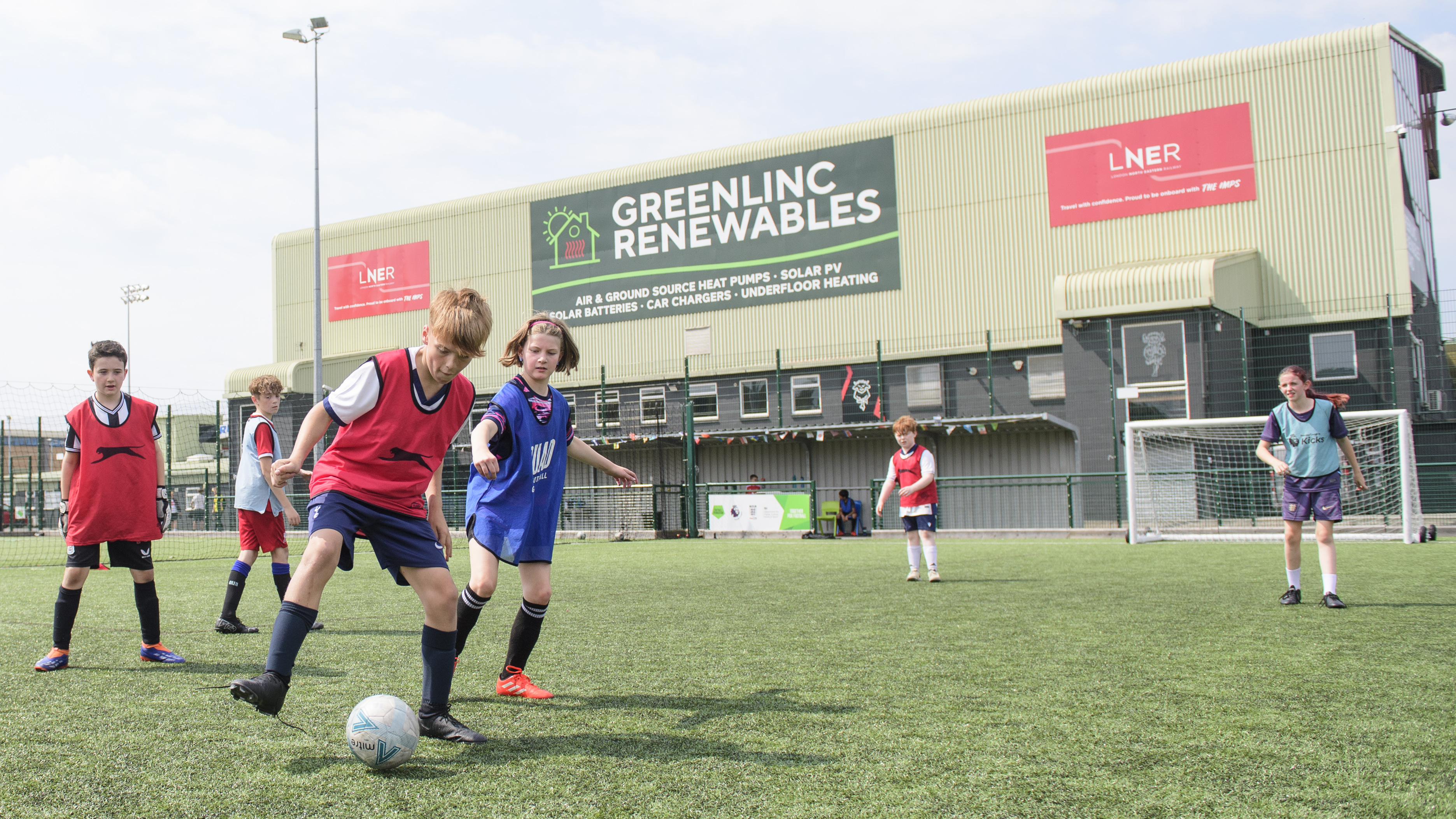 Children play football on a 3G pitch