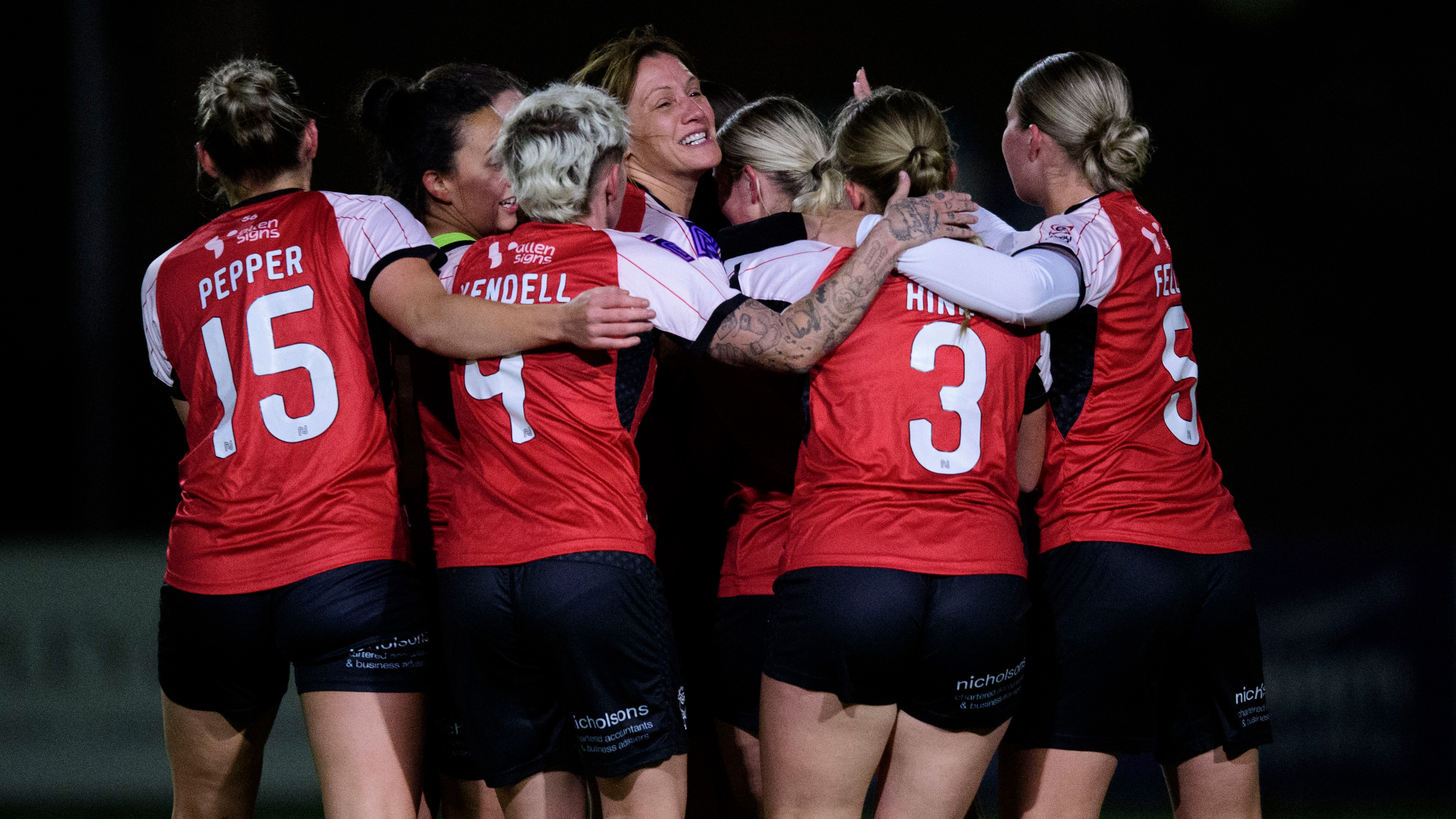 Lincoln City Women players celebrate a goal.