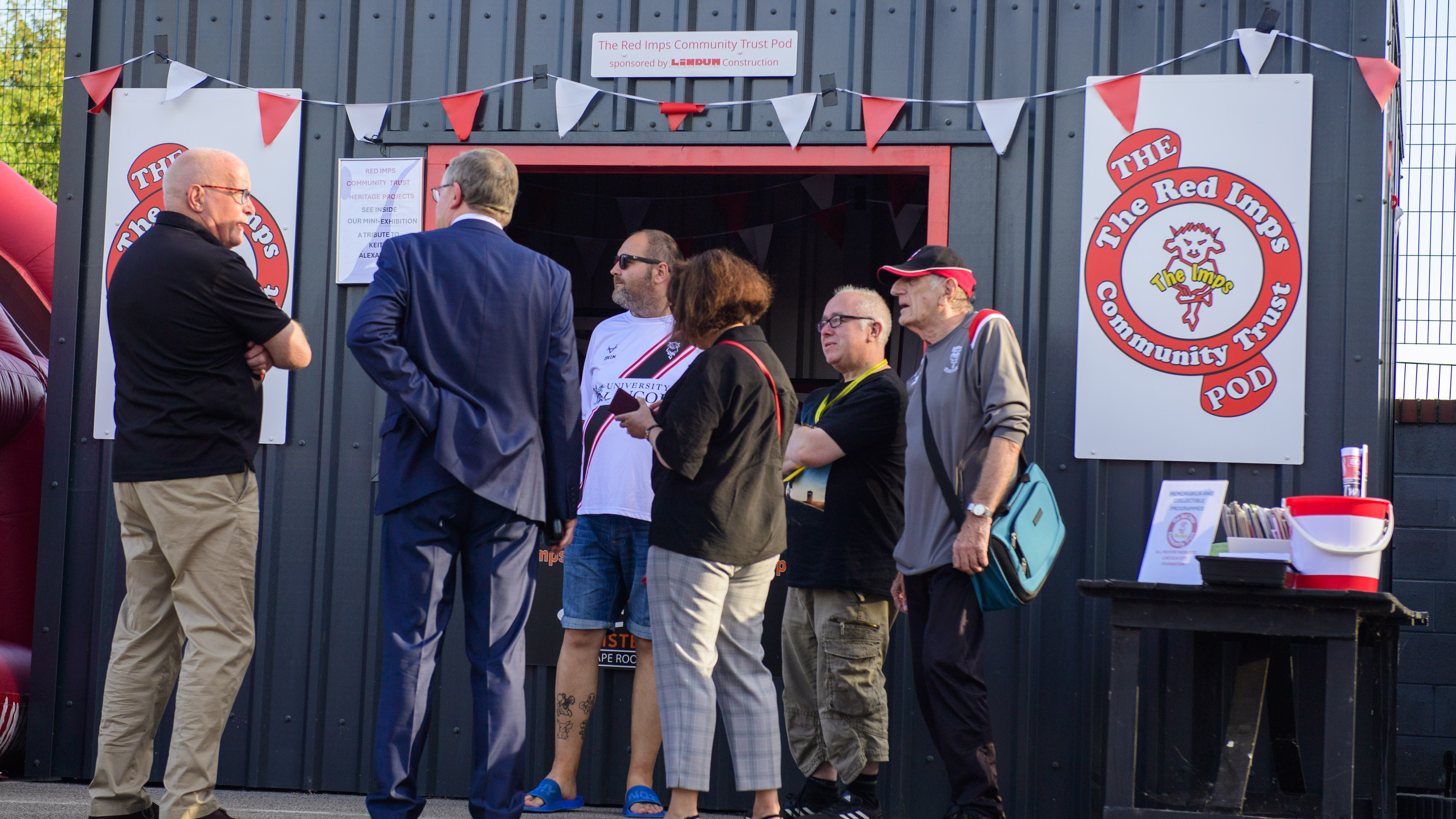 Supporters stand outside the Red Imps Community Trust "pod"