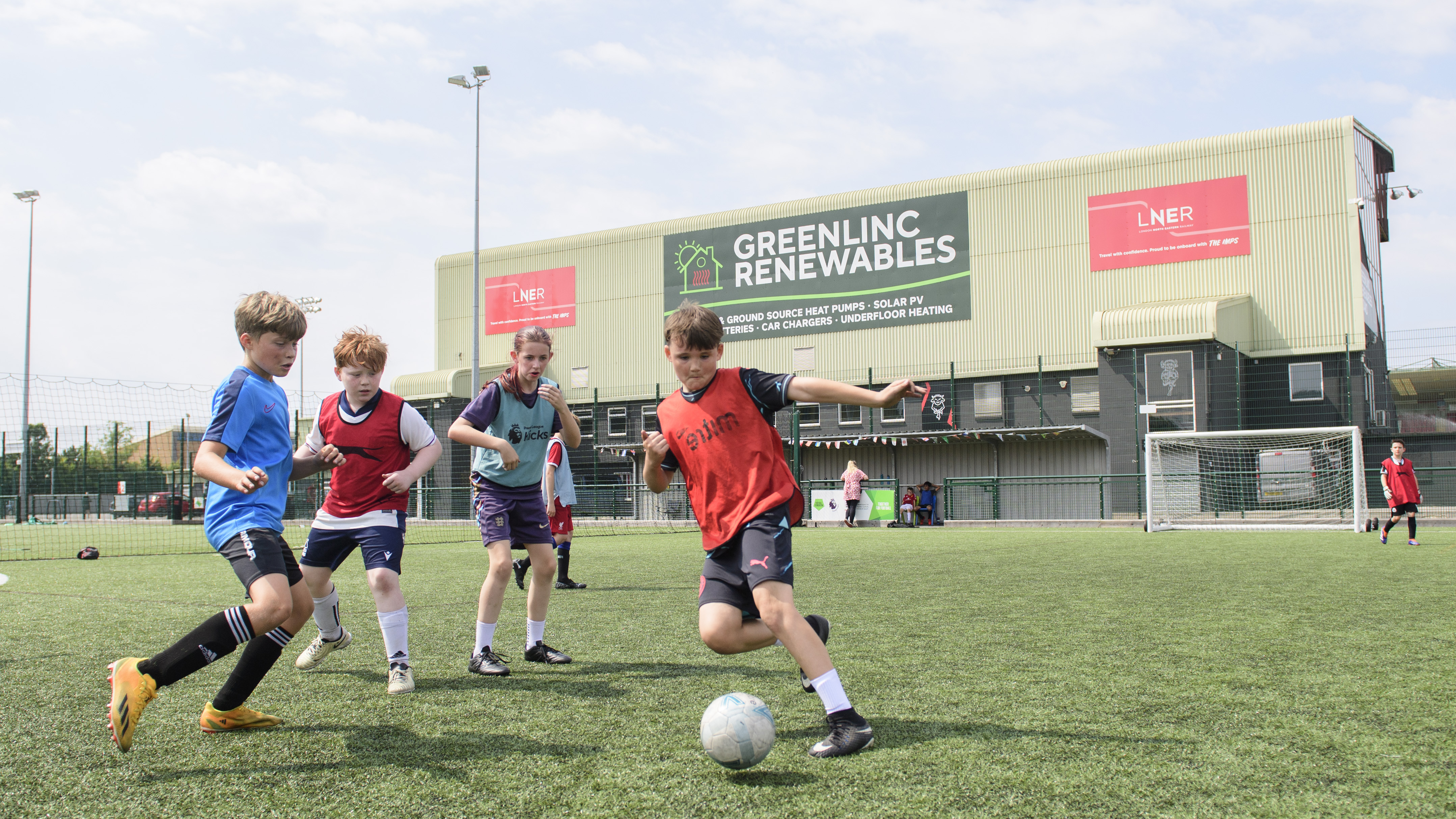 Children play football on a 3G pitch