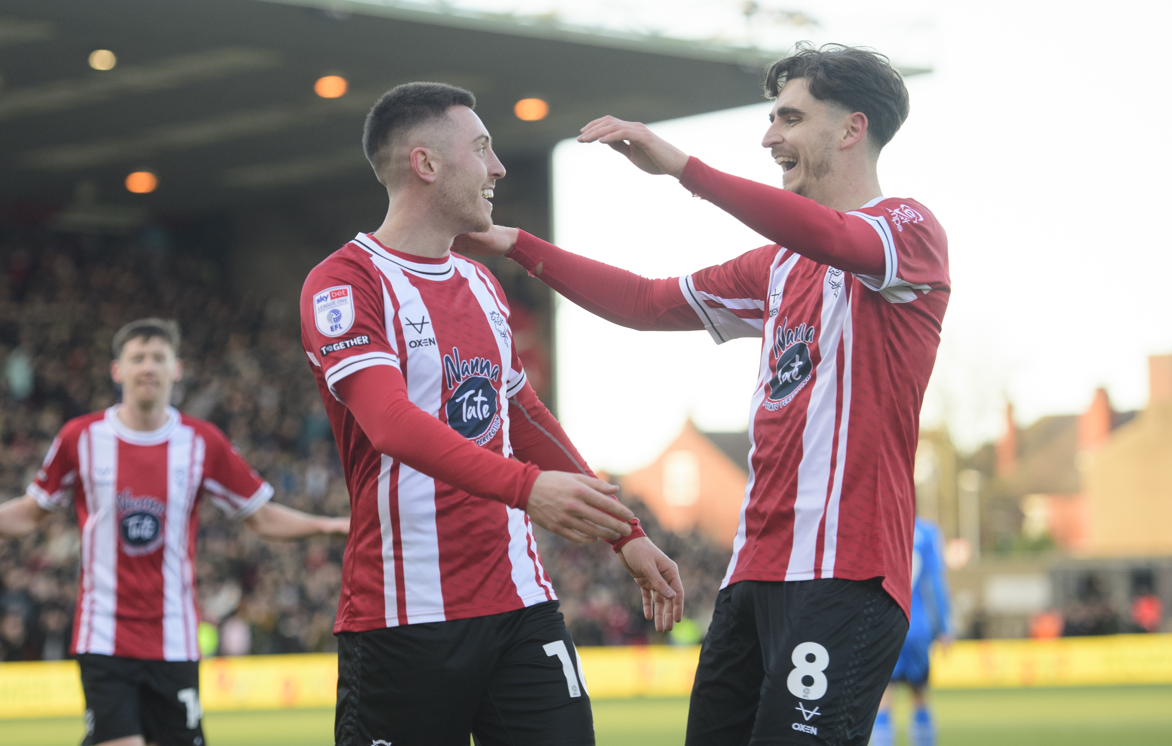 Two Lincoln City players celebrating 