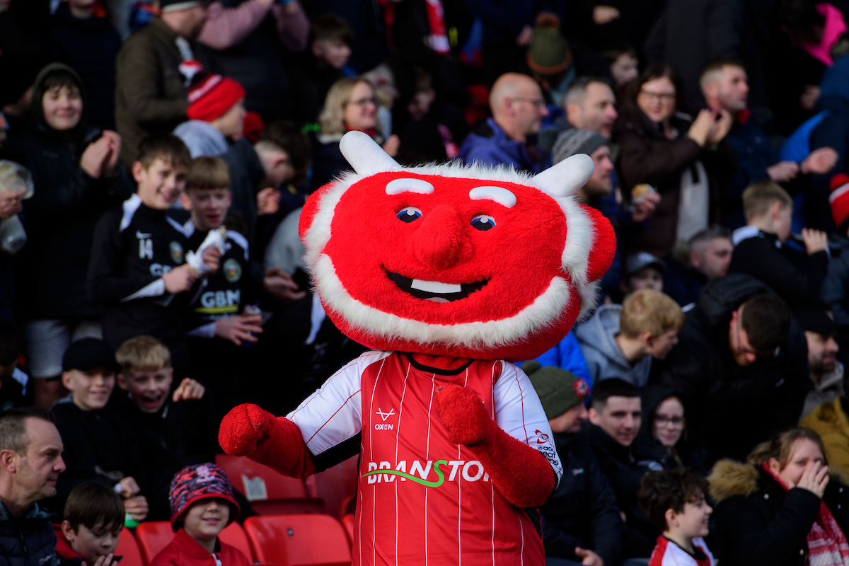 Poacher the Imp celebrates a goal in front of the Fun Farm Family Area