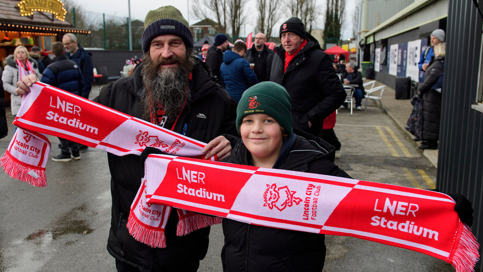 A young and older pair of City fans in the Fan Village