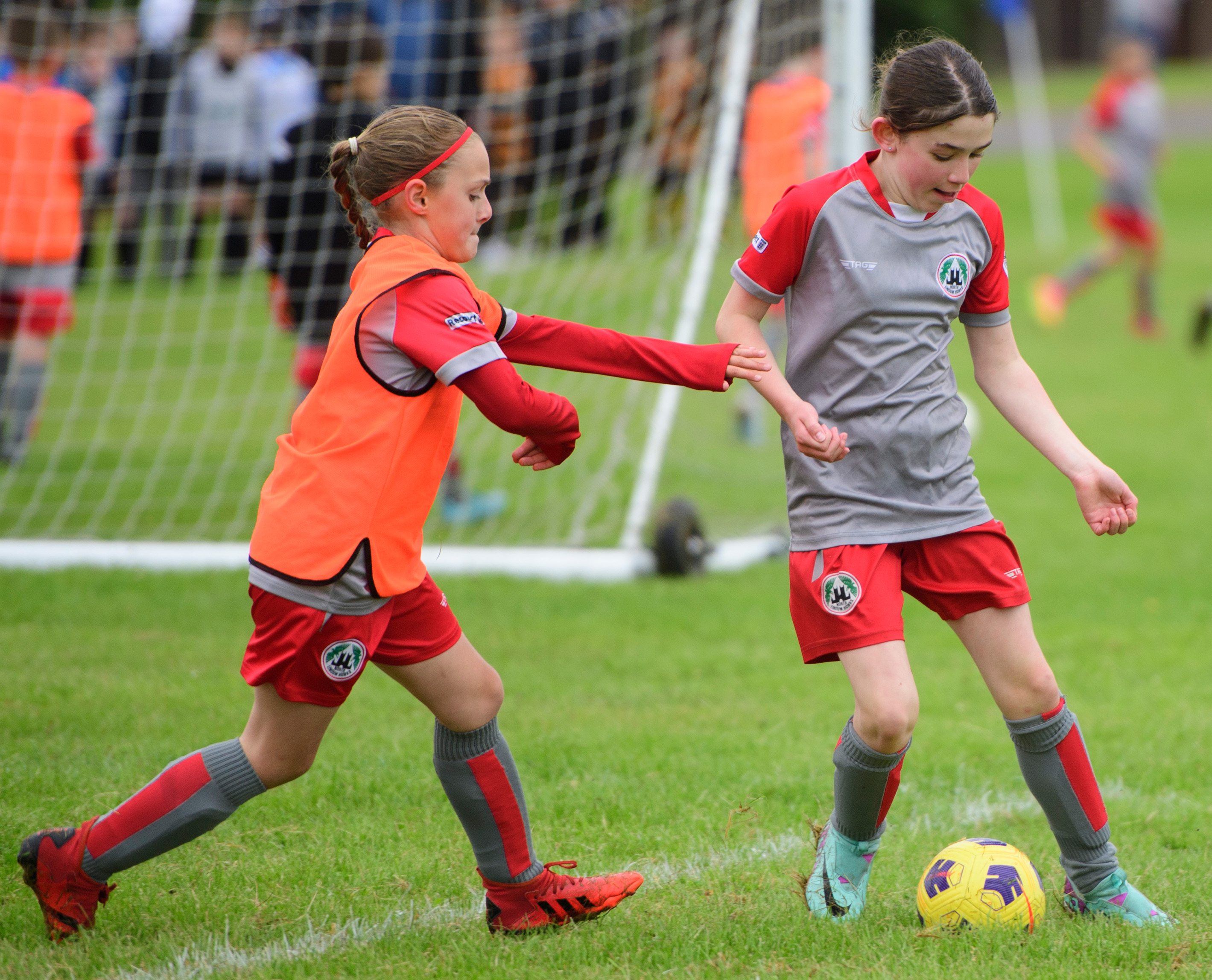Two girls playing football.