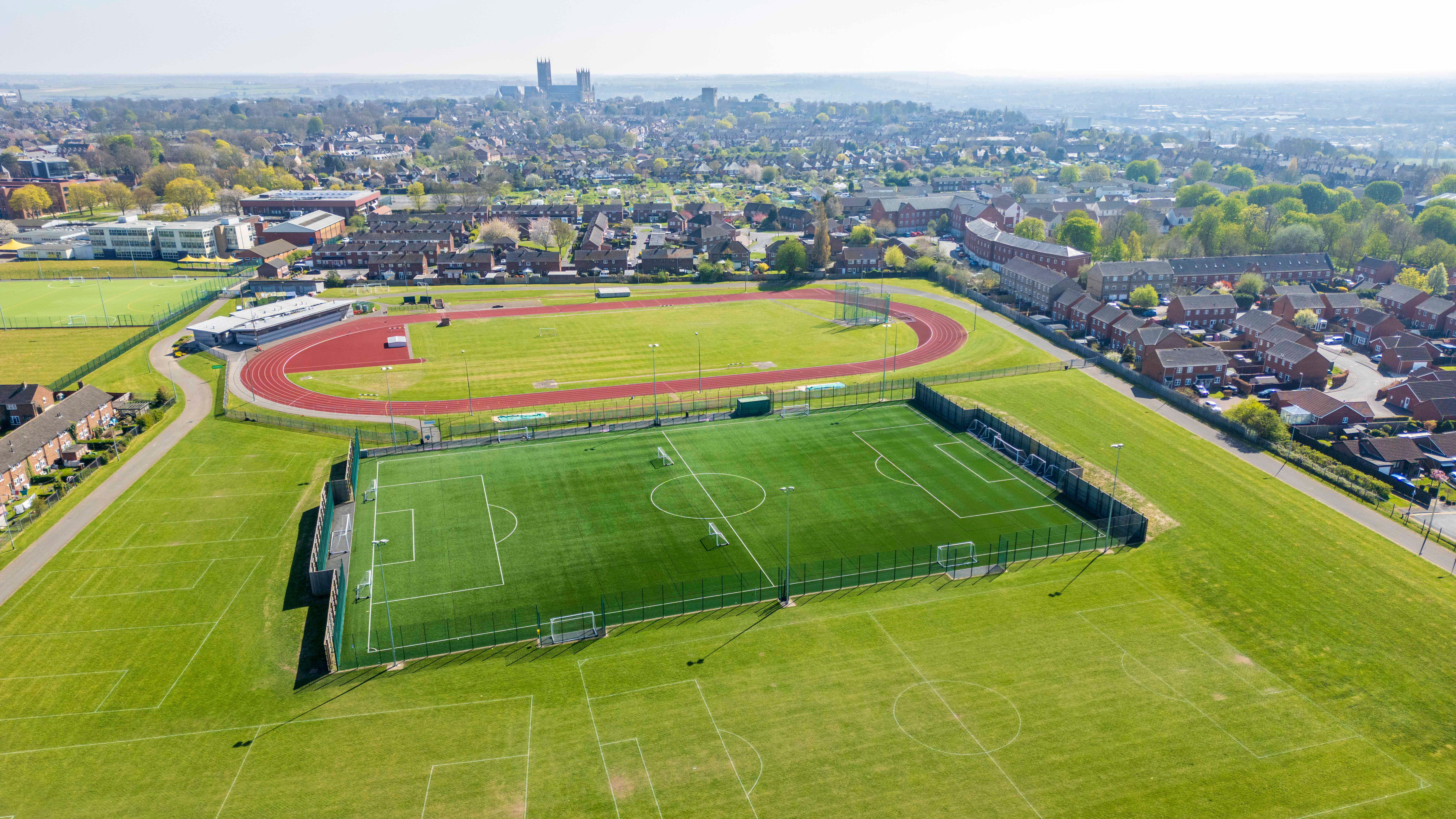 An aerial view of the outside pitches at Yarborough Leisure Centre.  At the top is a running track, below that is a 3G sports pitch then below that are grass pitches.