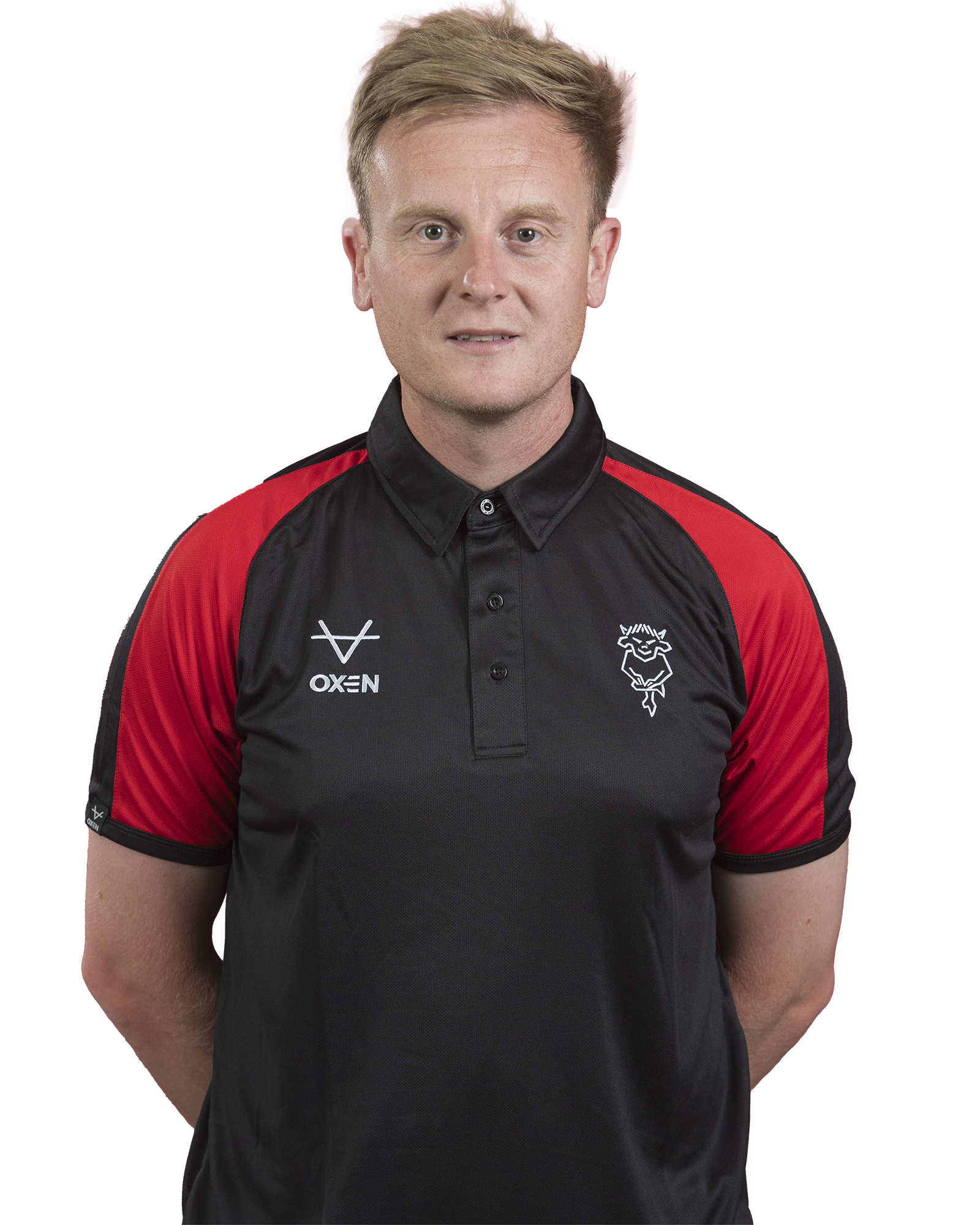 Joe Hutchinson poses in a black polo shirt