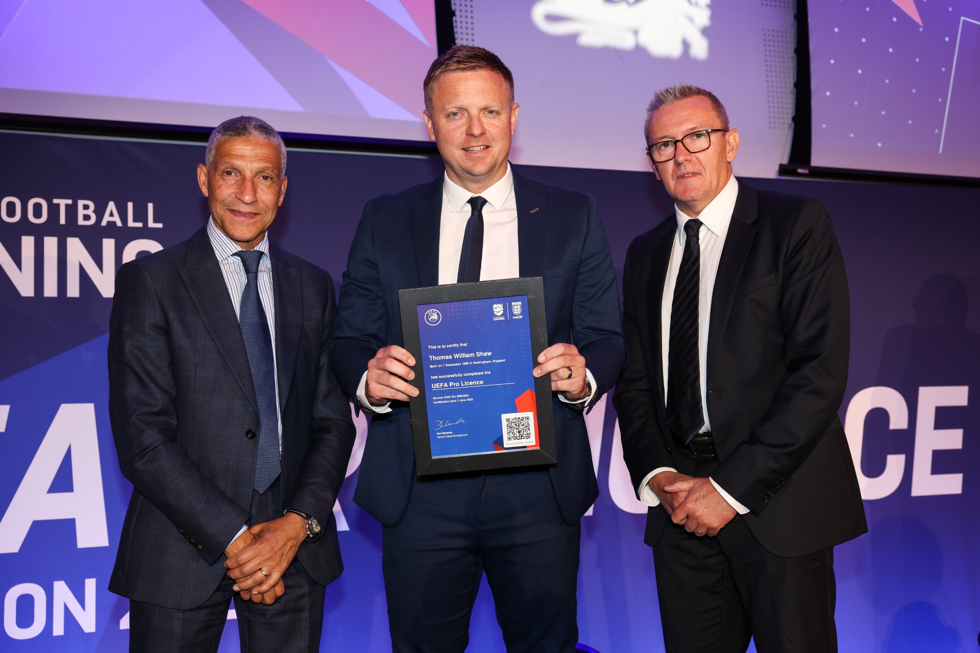 A photo of Lincoln City assistant head coach Tom Shaw receiving his UEFA Pro License