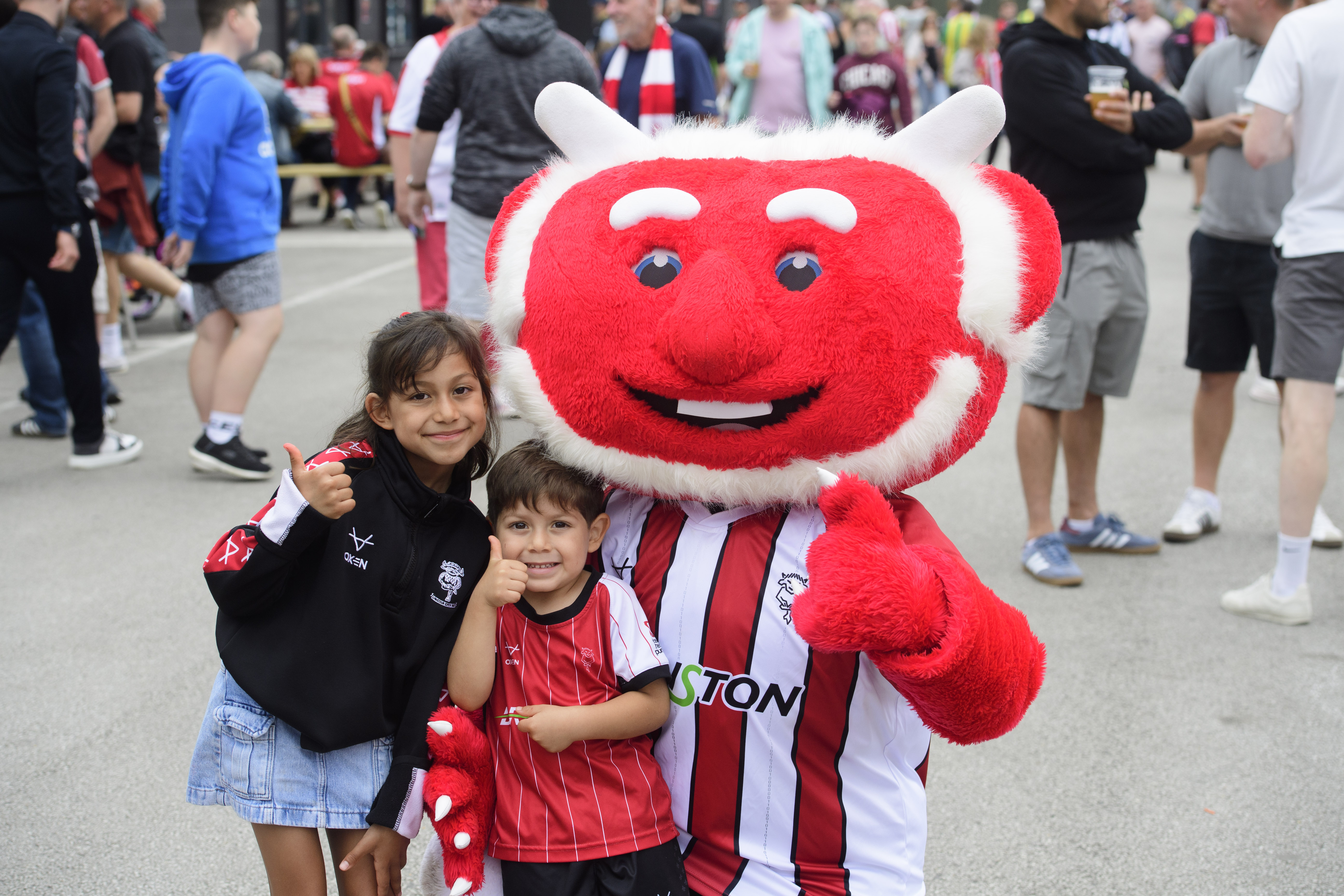 Two children pose with Poacher the Imp