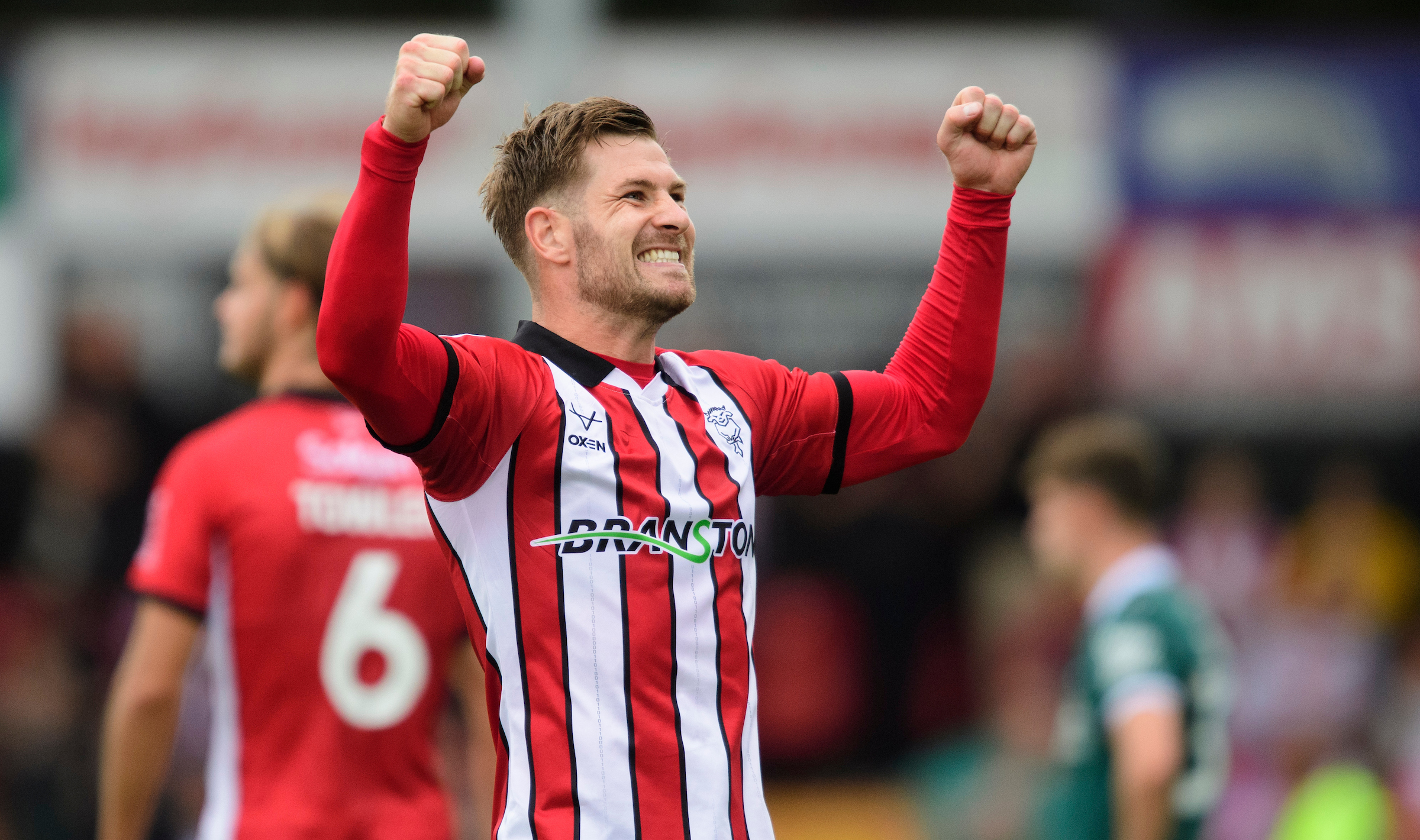 James Collins of Lincoln City celebrates scoring his side's third goal, from the penalty spot, during the EFL Sky Bet League One match between Lincoln City and Plymouth Argyle at LNER Stadium, Lincoln.