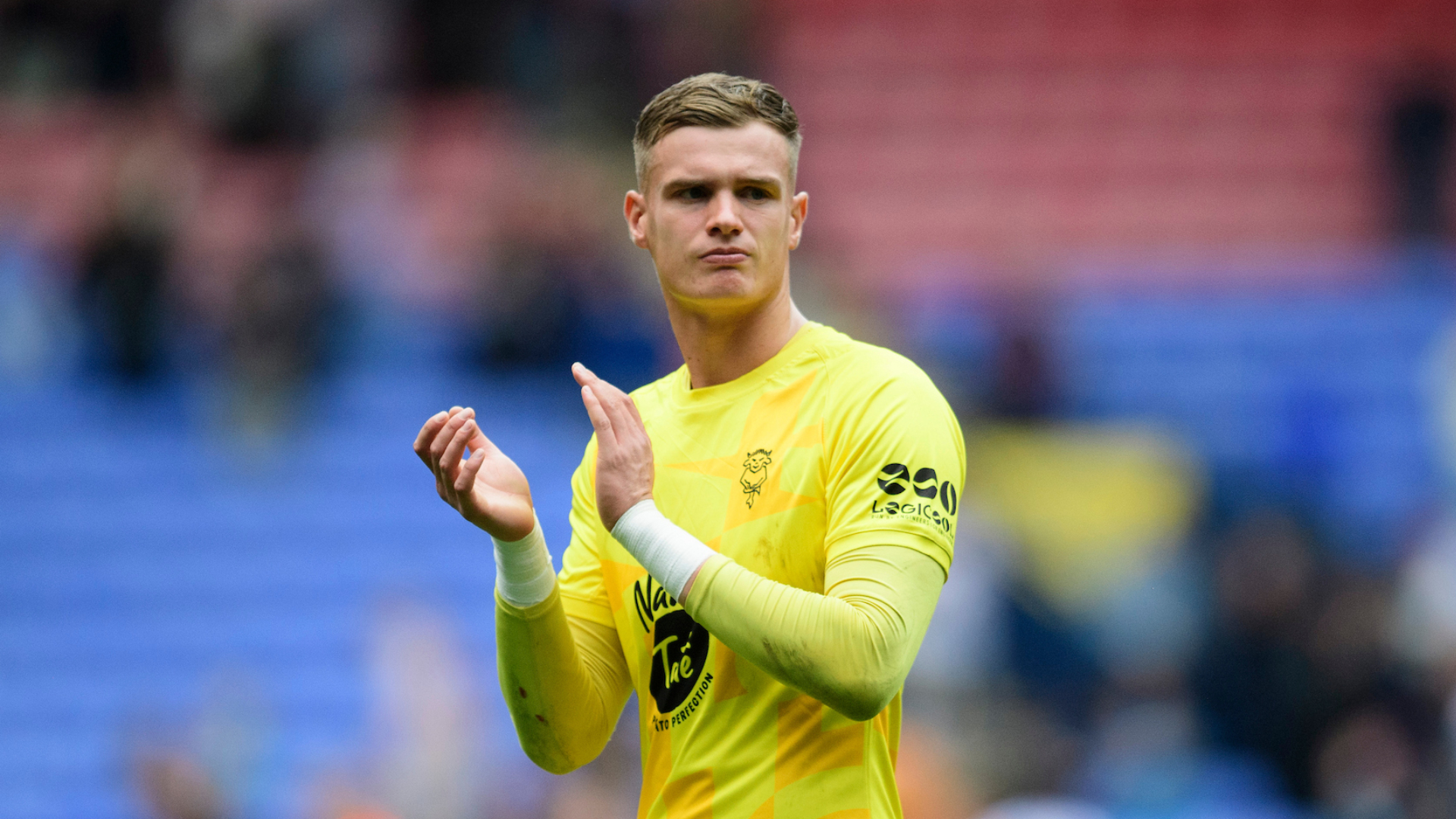 George Wickens of Lincoln City applauds the fans at the final whistle following the EFL Sky Bet League One match between Bolton Wanderers and Lincoln City at Toughsheet Community Stadium, Bolton.