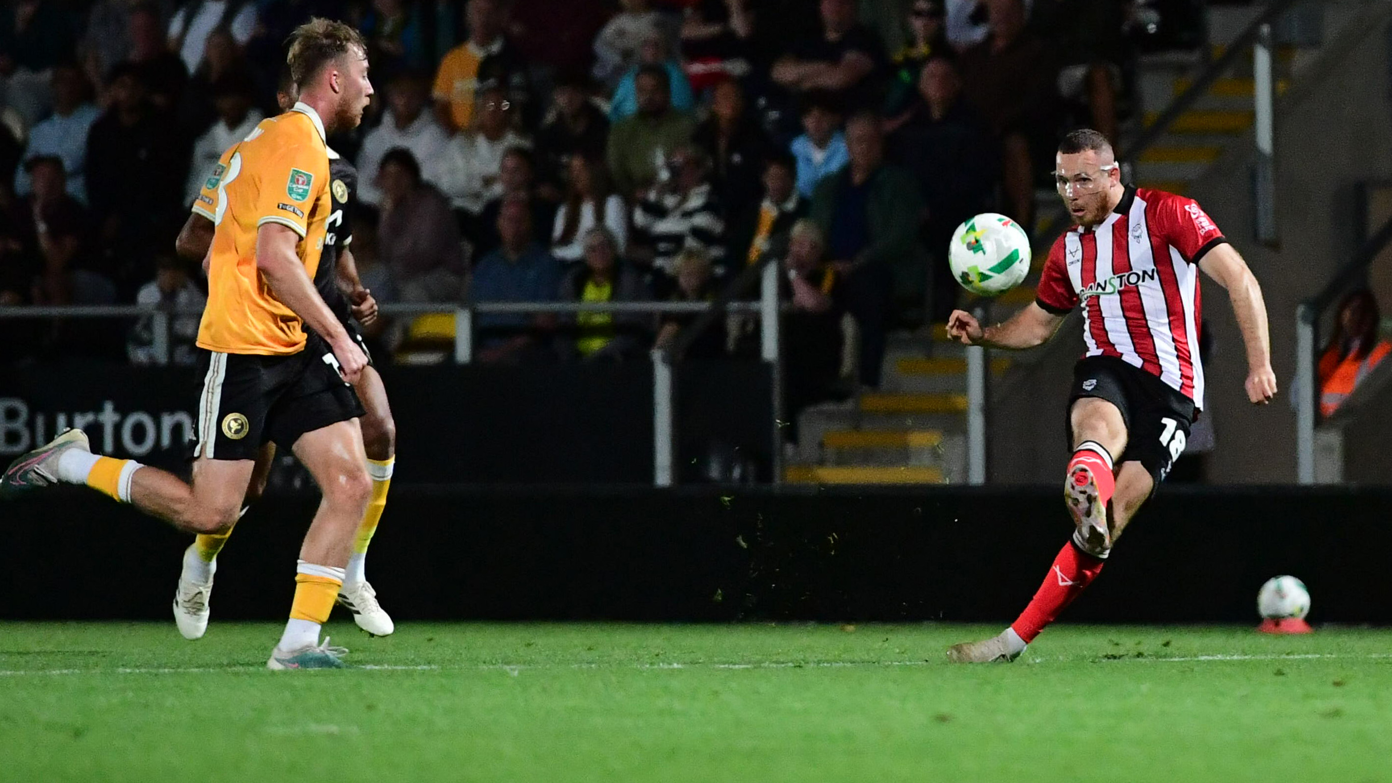 Ben House kicks the ball to score for Lincoln CIty