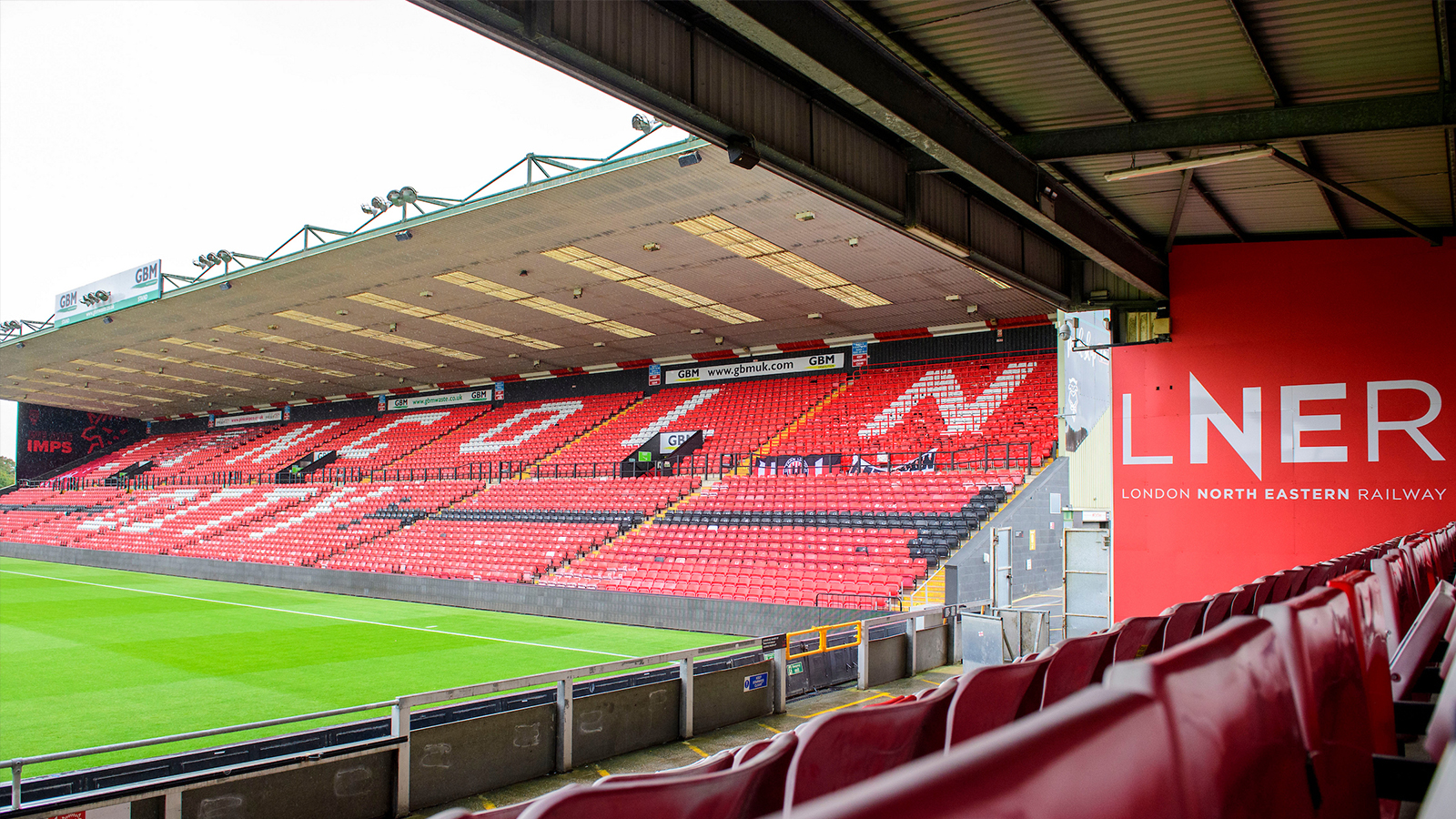 A general view of LNER Stadium, home of Lincoln City, showing LNER branding in the Stacey West Stand and the GBM Stand prior to the Vertu Trophy Northern Section group D match between Lincoln City and Notts County at LNER Stadium, Lincoln.