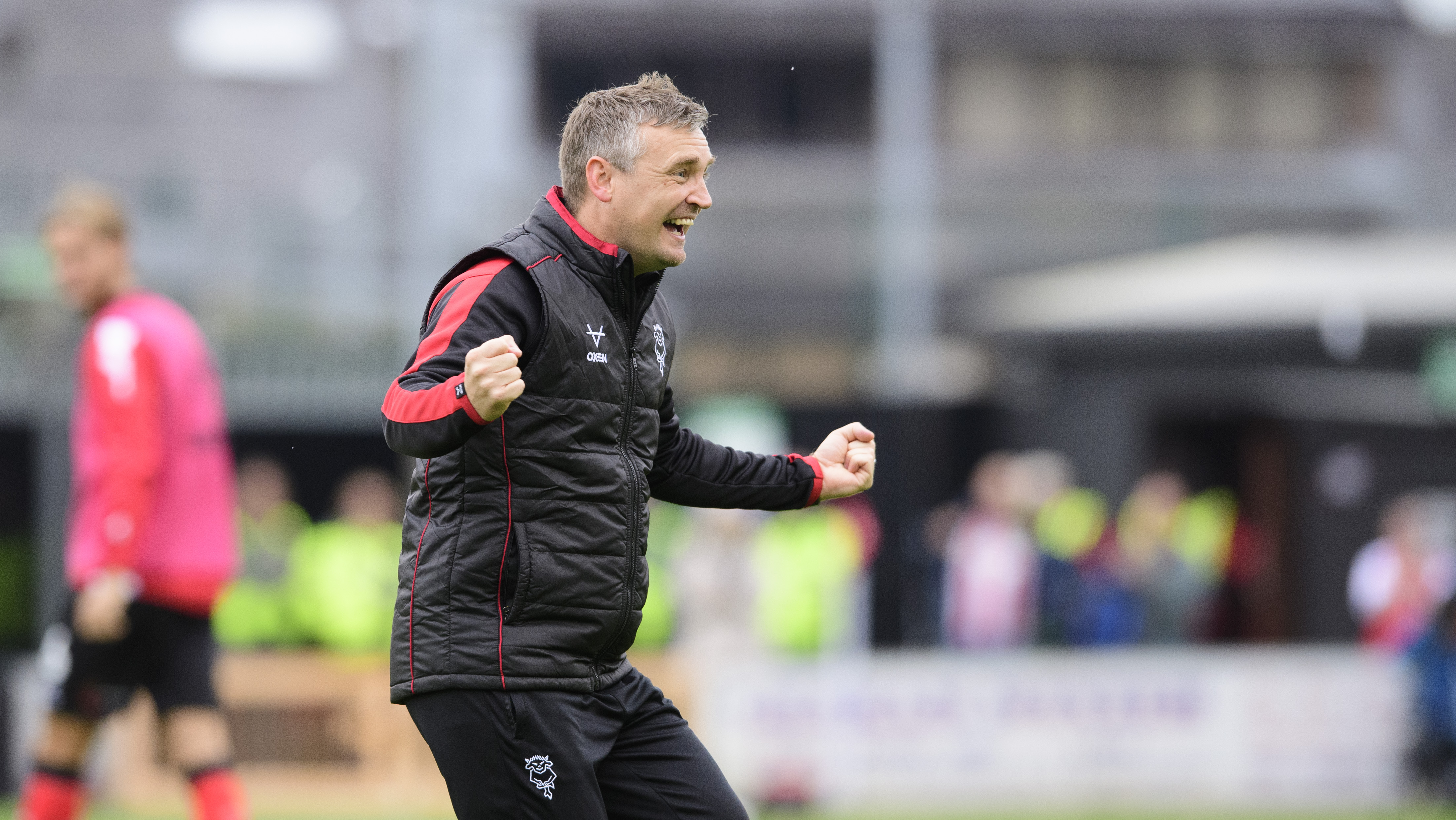 Michael Skubala celebrates after a win. He is wearing a black gillet