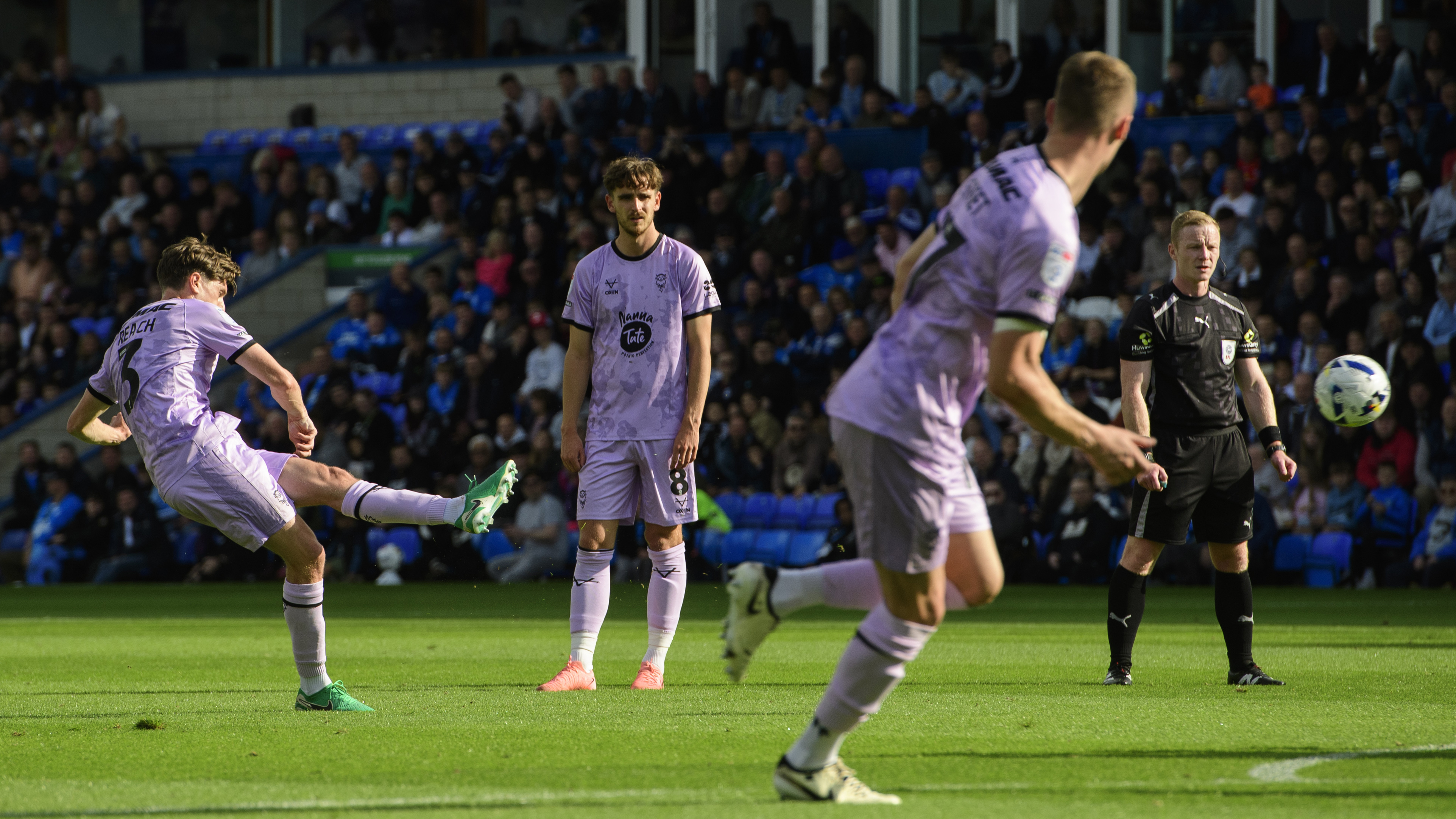 Adam Reach kicks the ball towards goal.