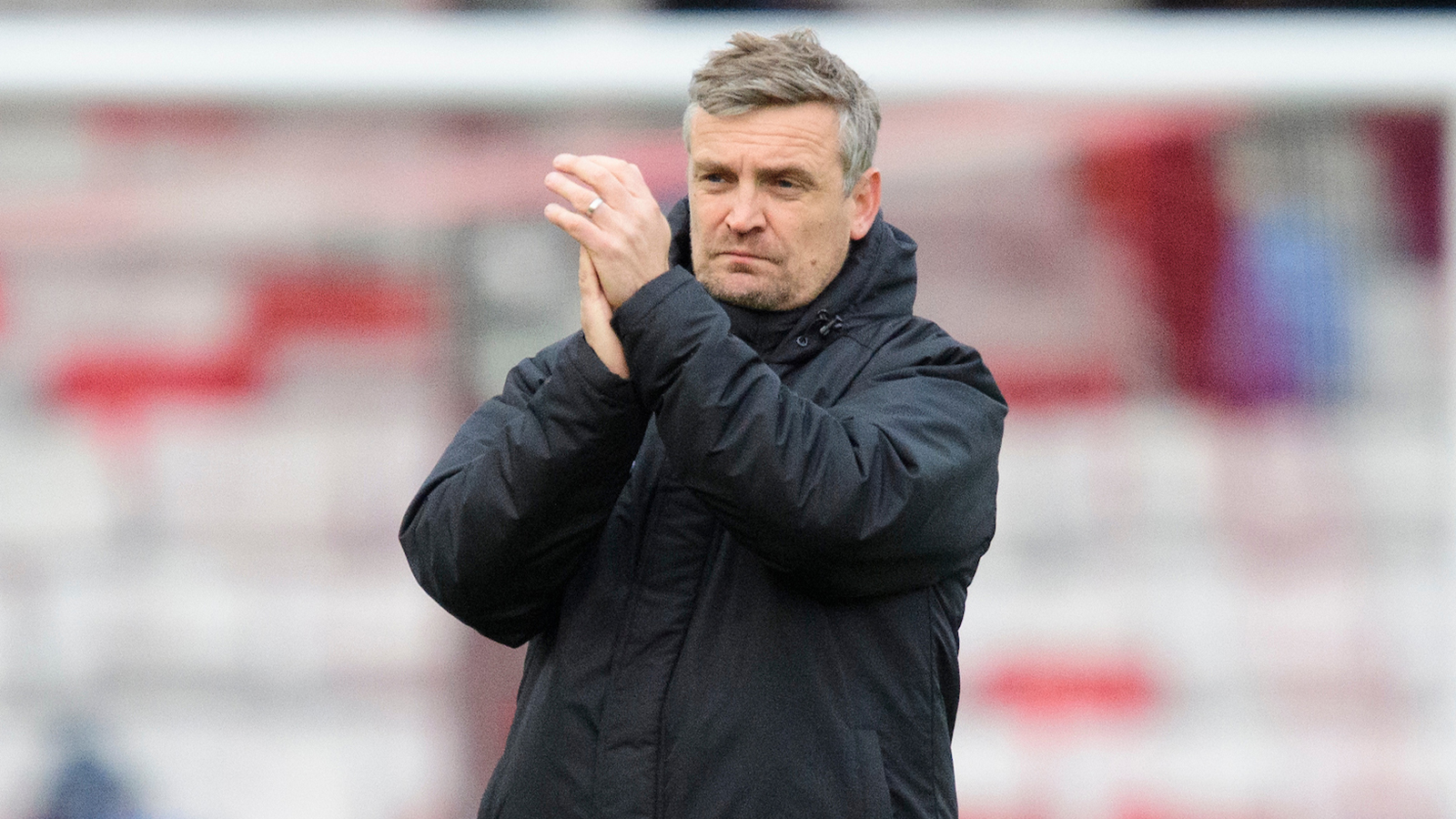 Michael Skubala applauds fans after the game against Exeter City
