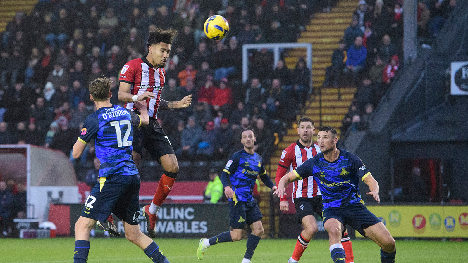 Frankie Okoronkwo leaps to head in a goal against Doncaster Rovers