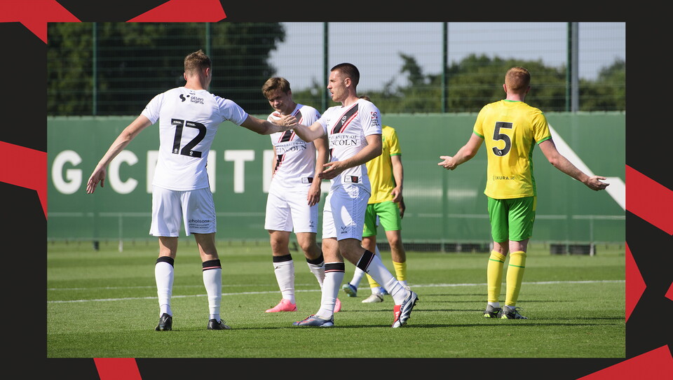 Lincoln City players congratulate Dom Jefferies after his goal