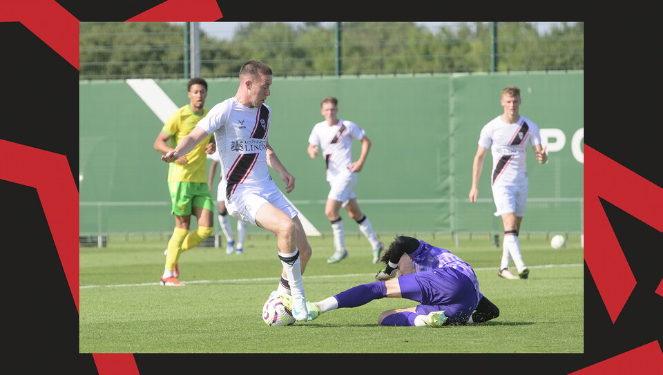 The Norwich City goalkeeper gets a foot to the ball ahead of Jack Moylan
