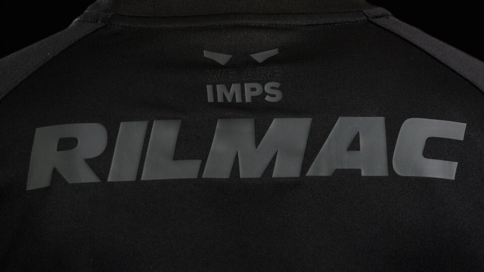 A close up of Rilmac on the back of Lincoln City's all-black third kit for 2024/25