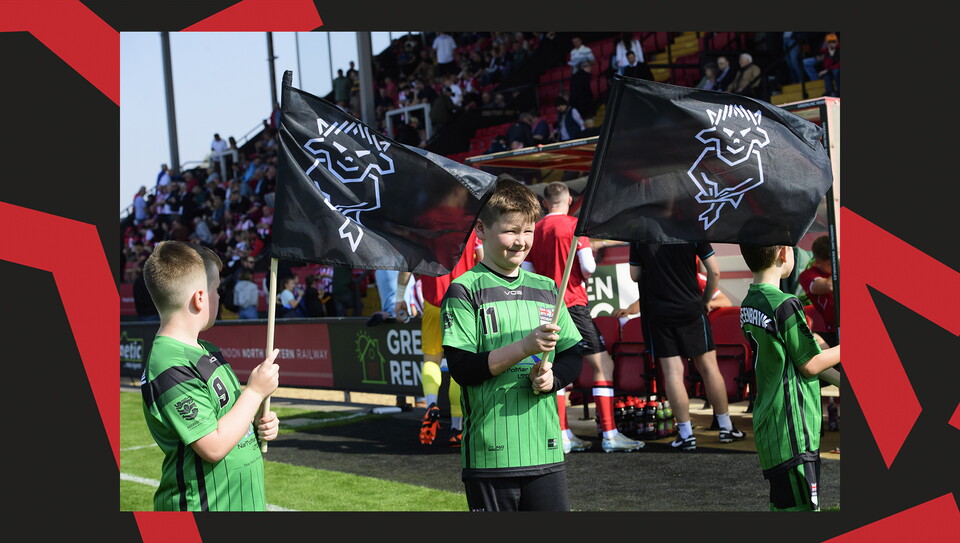 Young fans enjoying a matchday experience at Lincoln City's home game against Wigan Athletic.