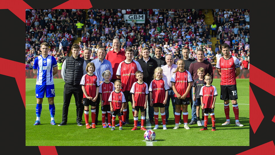 Young fans enjoying a matchday experience at Lincoln City's home game against Wigan Athletic.