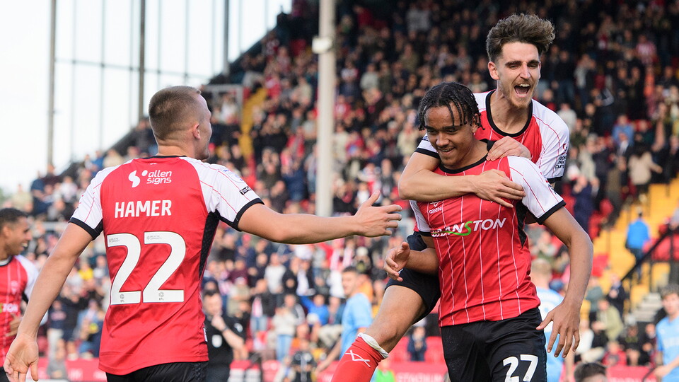 Tom Hamer and Tom Bayliss congratulate Jovon Makama on his goal in City's 2-1 home win over Leyton Orient