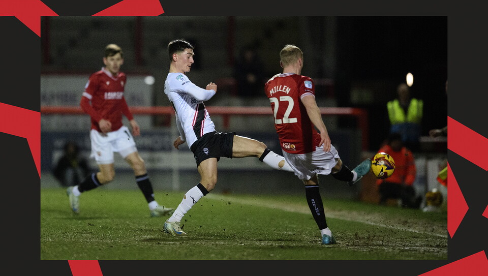 A match action image from the Imps' away Vertu Trophy game at Morecambe