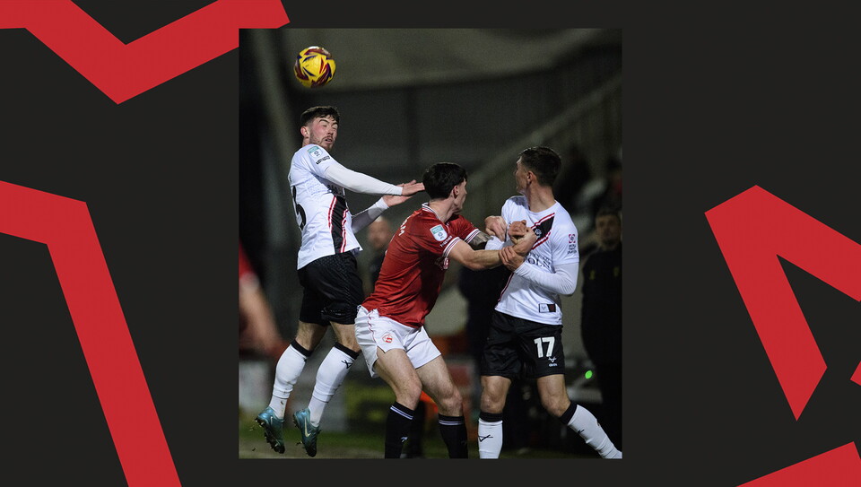 A match action image from the Imps' away Vertu Trophy game at Morecambe