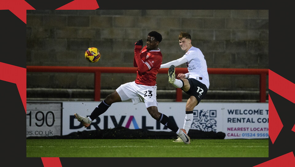 A match action image from the Imps' away Vertu Trophy game at Morecambe