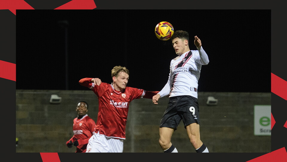 A match action image from the Imps' away Vertu Trophy game at Morecambe