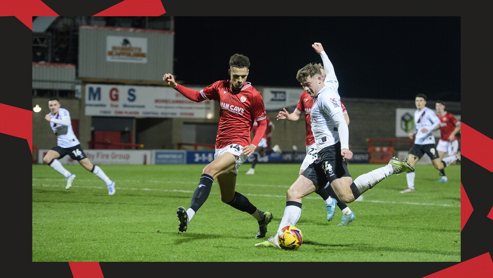 A match action image from the Imps' away Vertu Trophy game at Morecambe