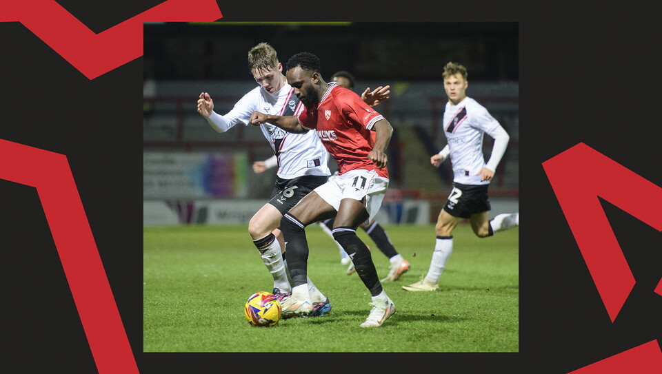 A match action image from the Imps' away Vertu Trophy game at Morecambe