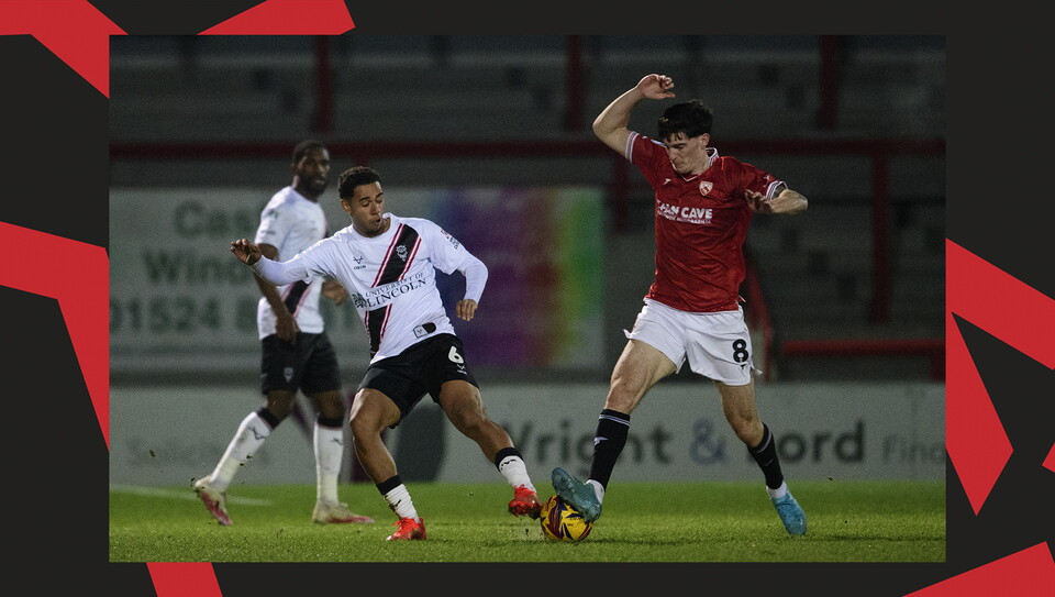 A match action image from the Imps' away Vertu Trophy game at Morecambe