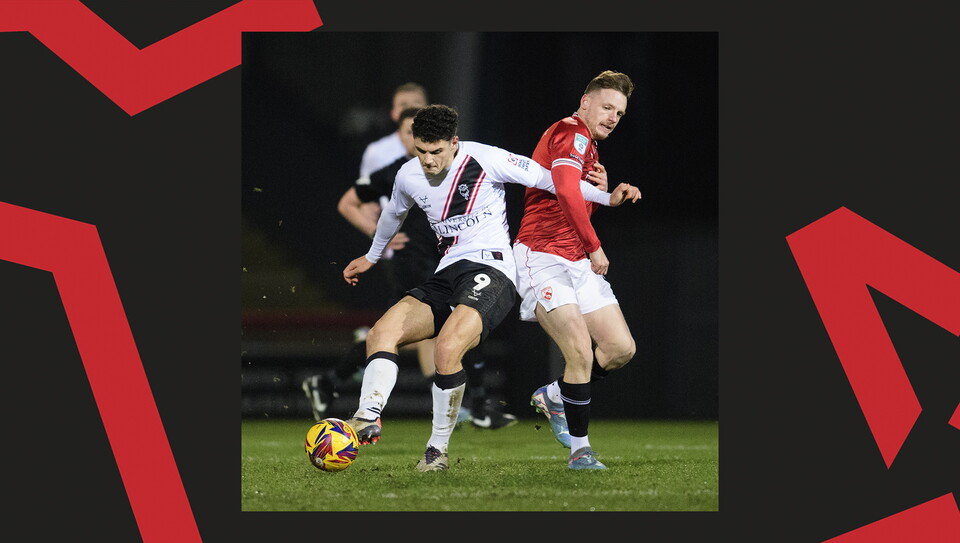 A match action image from the Imps' away Vertu Trophy game at Morecambe