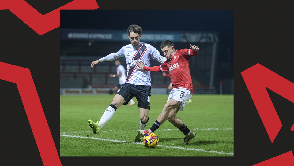 A match action image from the Imps' away Vertu Trophy game at Morecambe