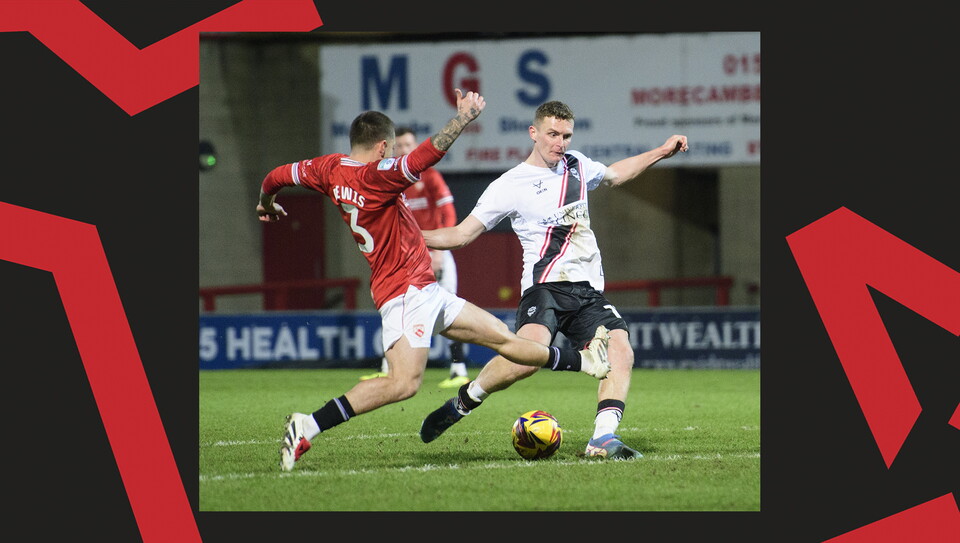 A match action image from the Imps' away Vertu Trophy game at Morecambe