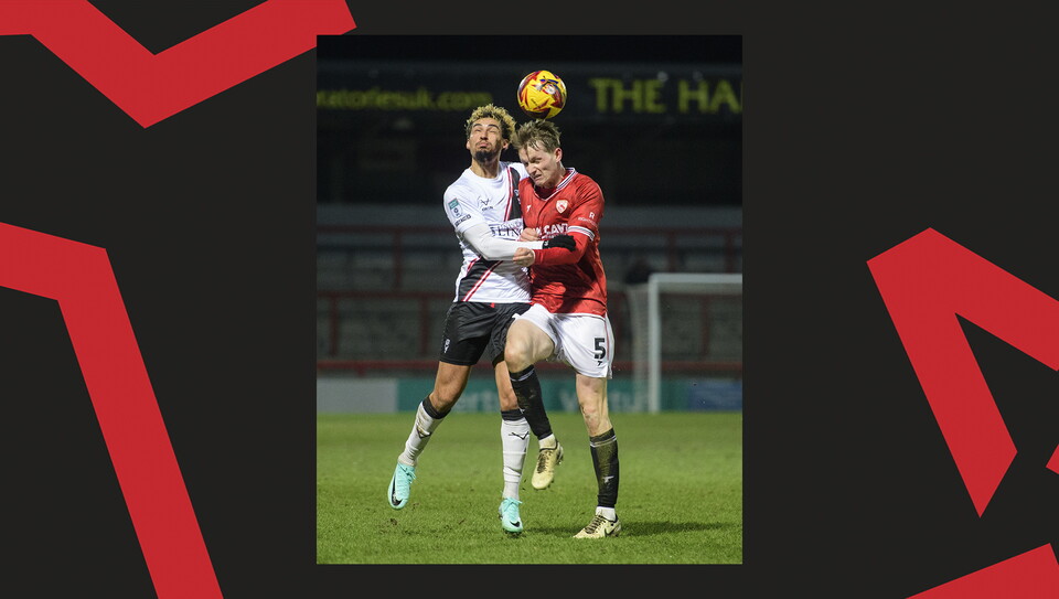 A match action image from the Imps' away Vertu Trophy game at Morecambe