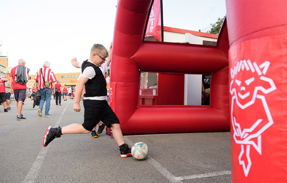 A young supporter shoots into the inflate goal in the University of Lincoln Fan Village