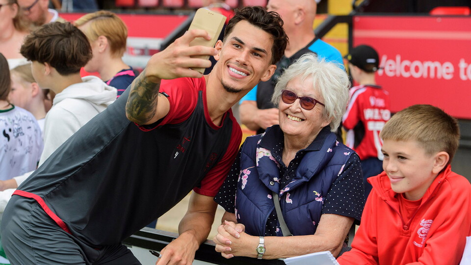 Lewis Montsma poses for a selfie with two Imps fans